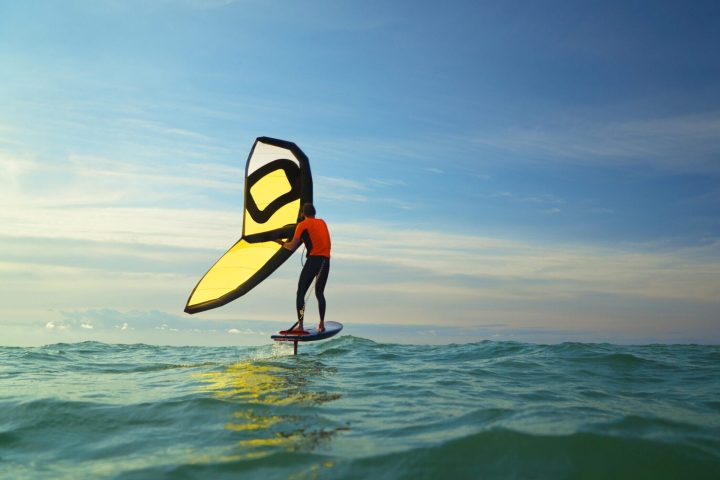 a person wingfoiling on a body of water